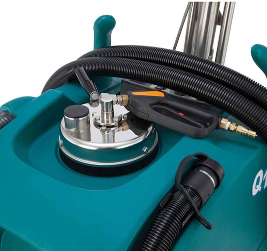 The tools for the Q12 Multi-Surface Cleaner secured on top of the machine.